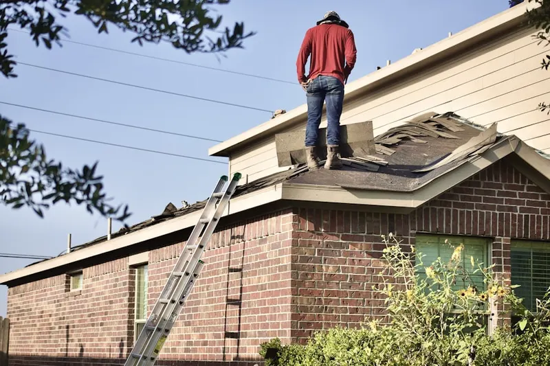 Professional roofer working on a residential roof in Fountain